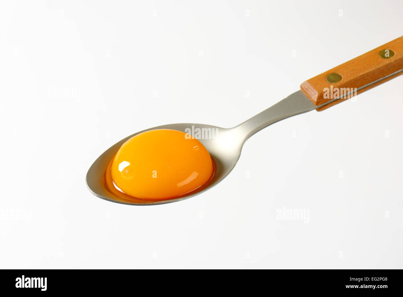 Raw egg yolk on a spoon Stock Photo Alamy