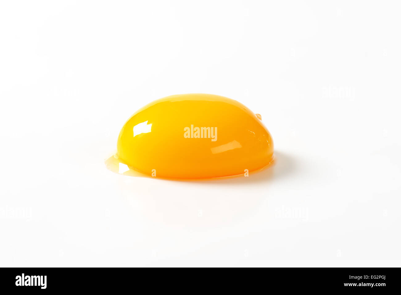 Raw egg yolk on white background Stock Photo - Alamy