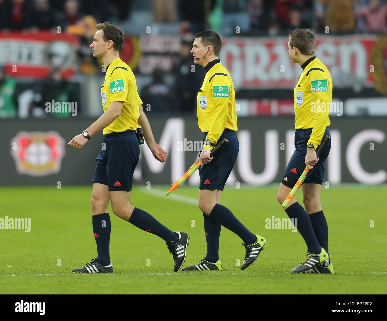 Leverkusen, Germany, soccer, Bundesliga, 14.02.2015, Bayer Leverkusen vs VfL Wolfsburg: Referee Bastian Dankert (L) leaves the pitch with linesmen Stefan Lupp (C) and Mark Borsch. Credit:  Juergen Schwarz/Alamy Live News Stock Photo