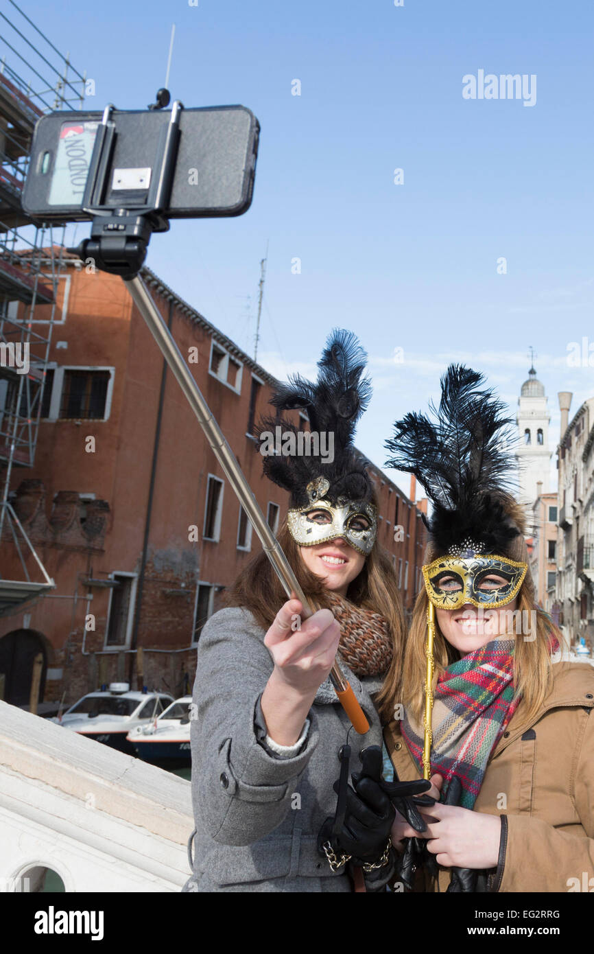 carnival at venice veneto italy two women take a selfie with the