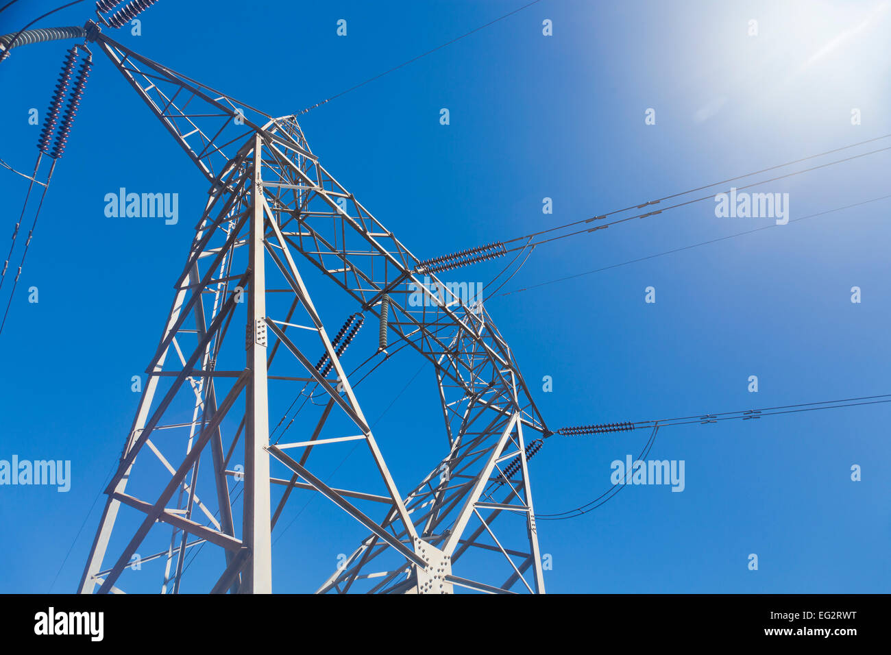 Electricity pylon against blue sky Stock Photo