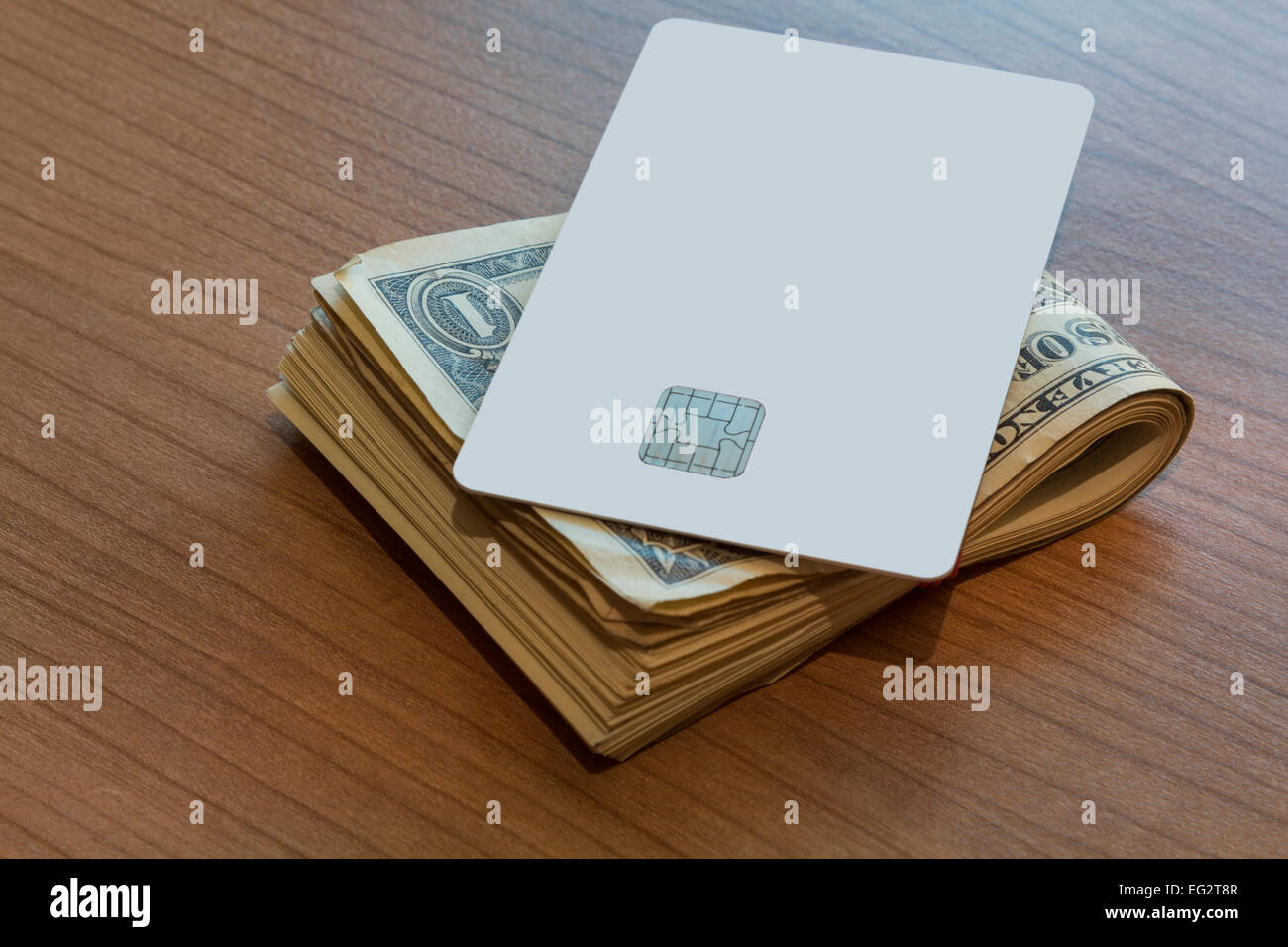A Blank white Credit or Debit Card and a couple of dollar notes on a ...