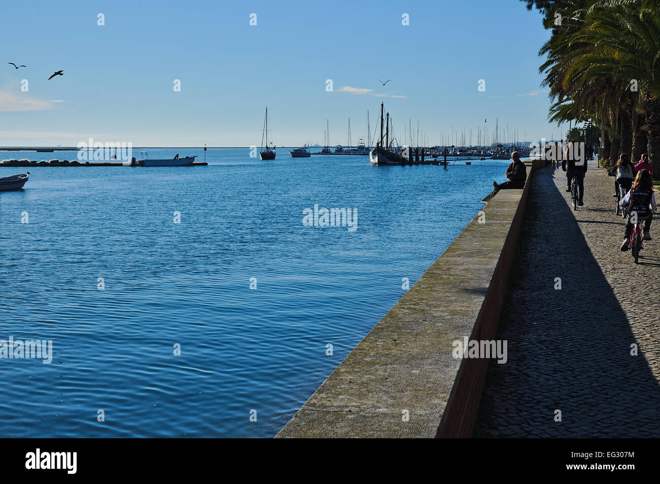 Olhao's city center. Boats and people passing by. Algarve, Portugal Stock Photo