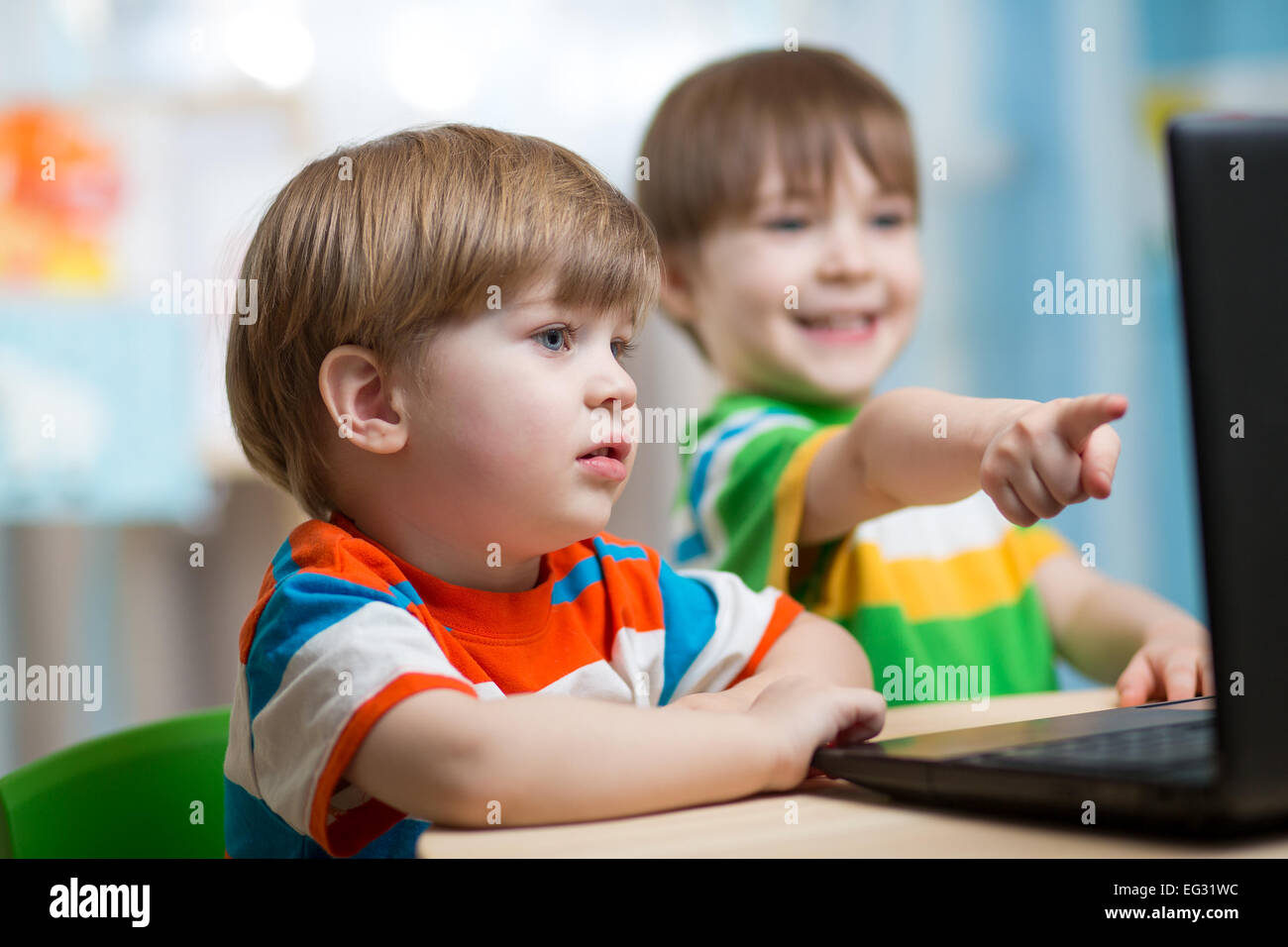 happy children looking at laptop Stock Photo