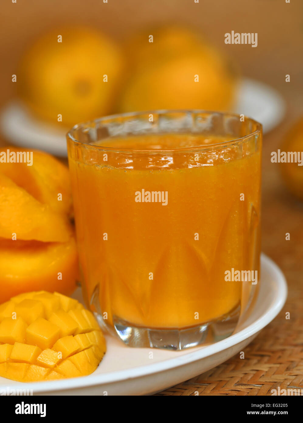 Ripe mangoes with juice in a glass Stock Photo