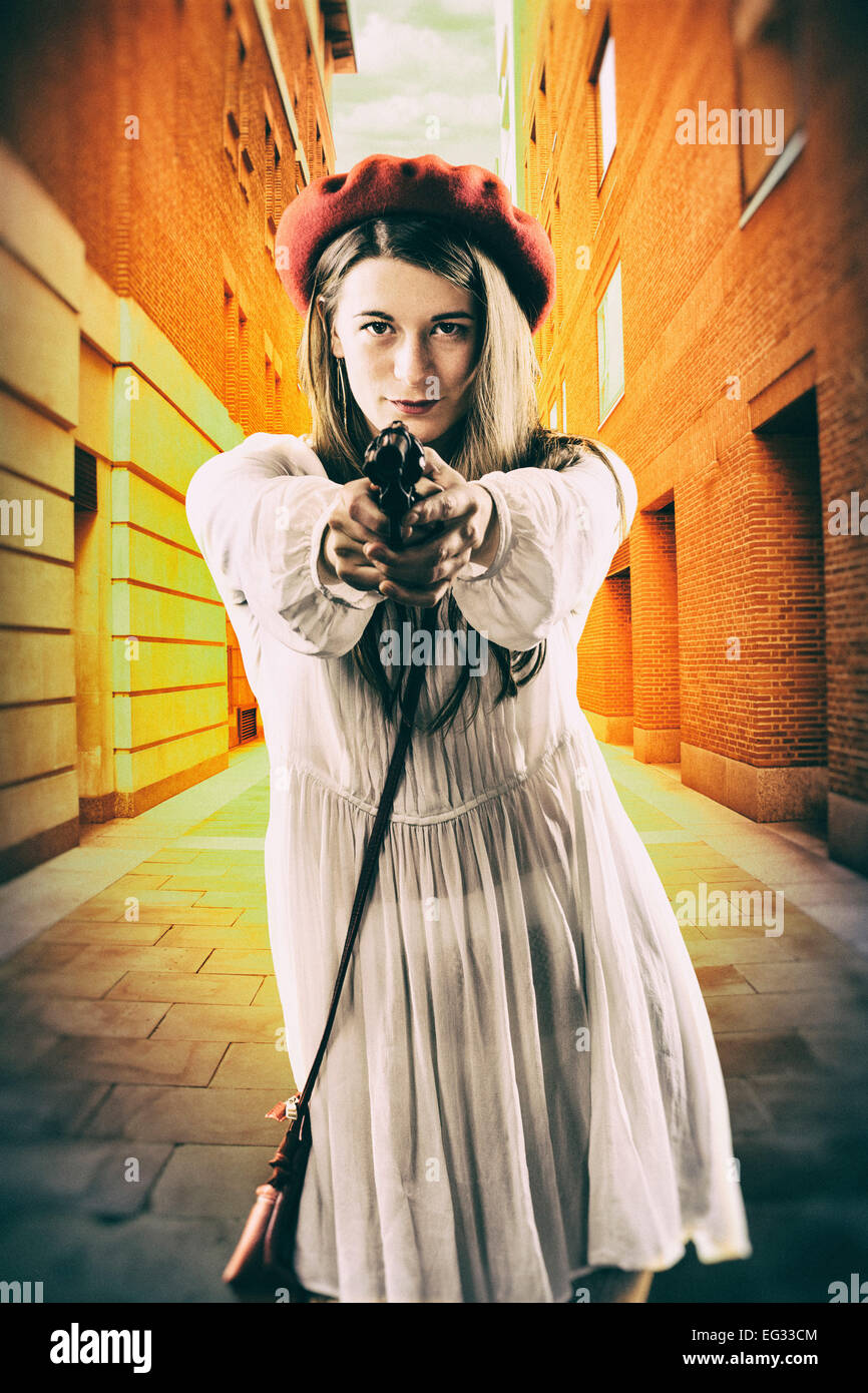 Woman pointing gun at goldfish stock photo rillypolice