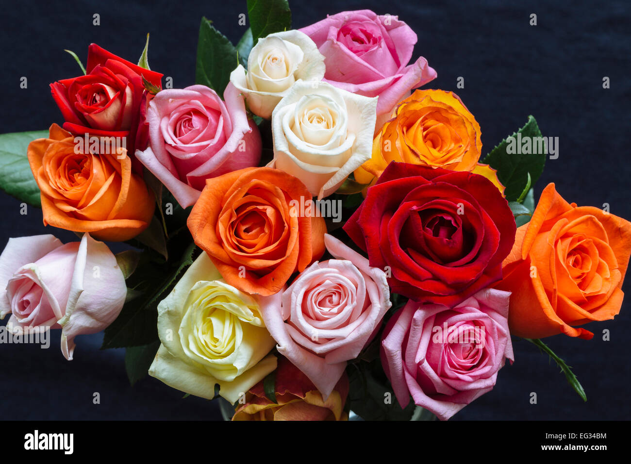 Bunch of colourful roses against dark surface Stock Photo - Alamy