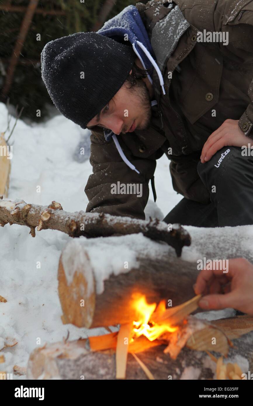 Helsinki, Finland. 12th Feb, 2015. A French tourist learns how to set fire on snow in Savukoski, northern Finland, on Feb. 12, 2015. As being trained to live in Arctic wilderness is becoming a popular recreation, many European choose to travel to Finnish Lapland to spend their winter vacations. © Li Jizhi/Xinhua/Alamy Live News Stock Photo