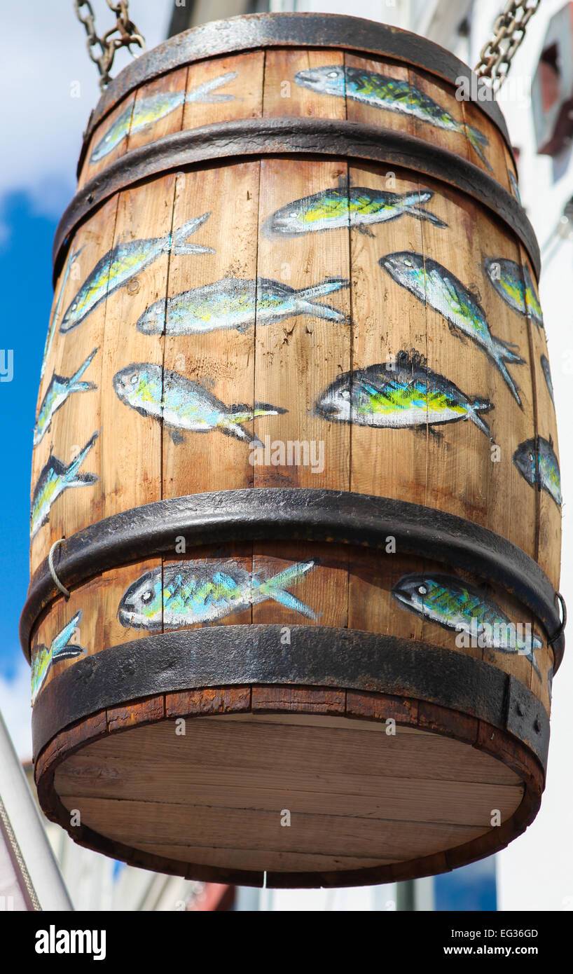 COPENHAGEN, DENMARK - APRIL 19, 2010: Big wooden barrel decorated with painted fish at a traditional herring restaurant in Nyhav Stock Photo
