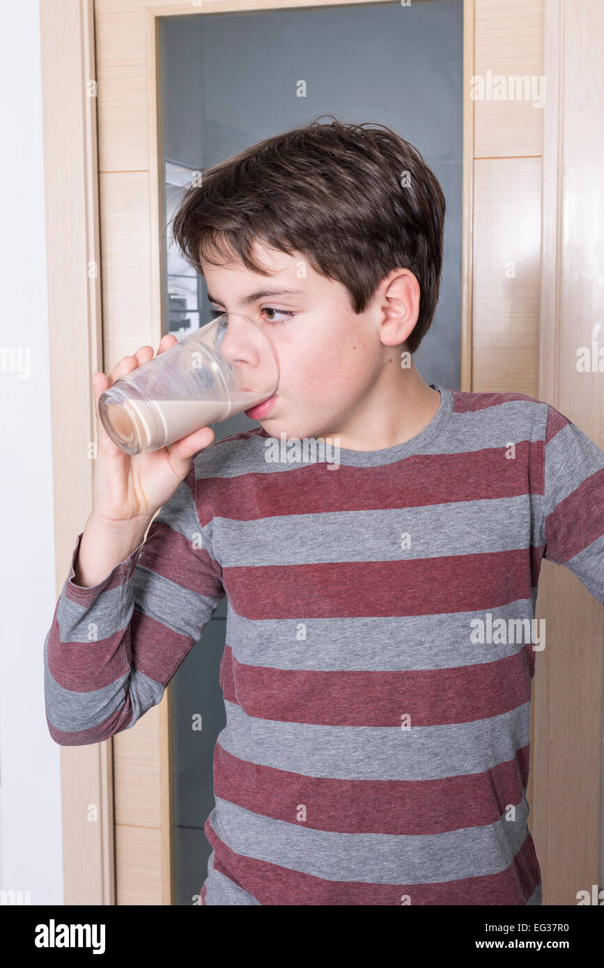 Young boy drinking a glass of chocolate milk Stock Photo