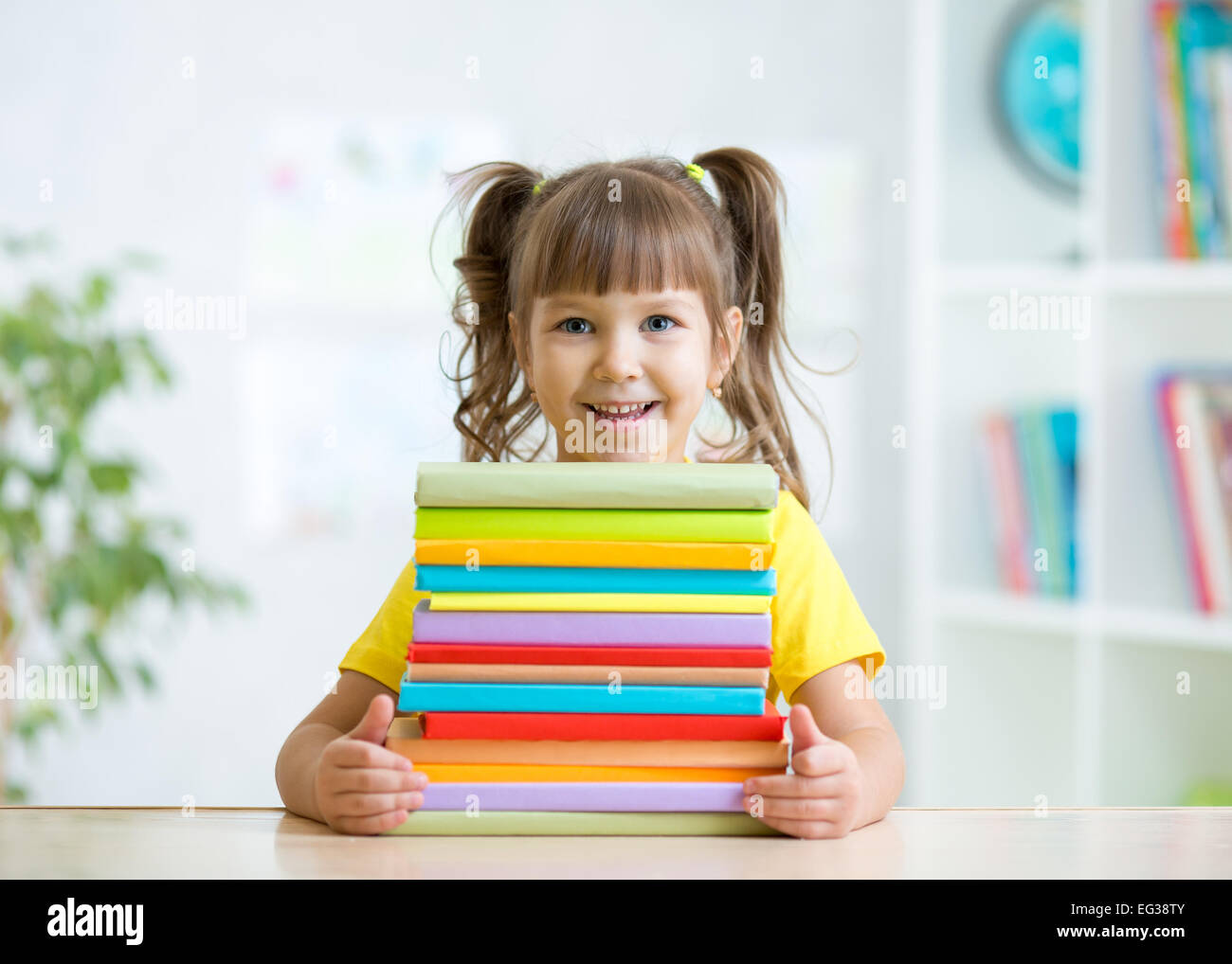 Cute kid girl preschooler with books Stock Photo - Alamy