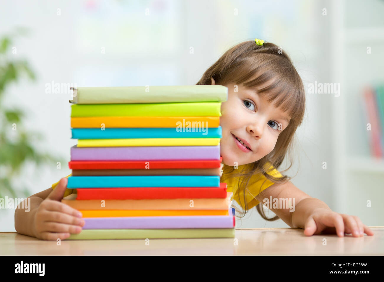 Cute kid girl preschooler with books Stock Photo - Alamy