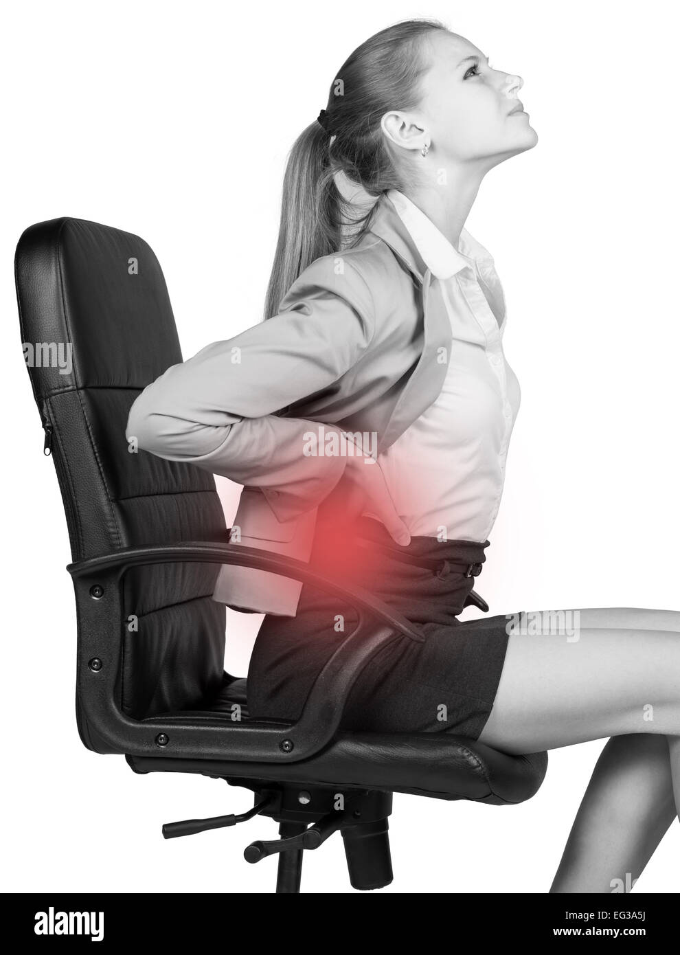 Businesswoman With Lower Back Pain Sitting On Office Chair Stock