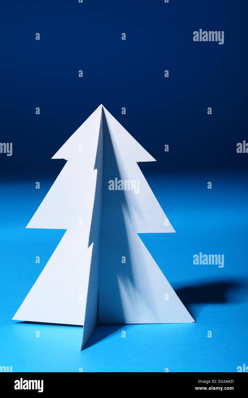 Paper Christmas tree over blue background Stock Photo - Alamy
