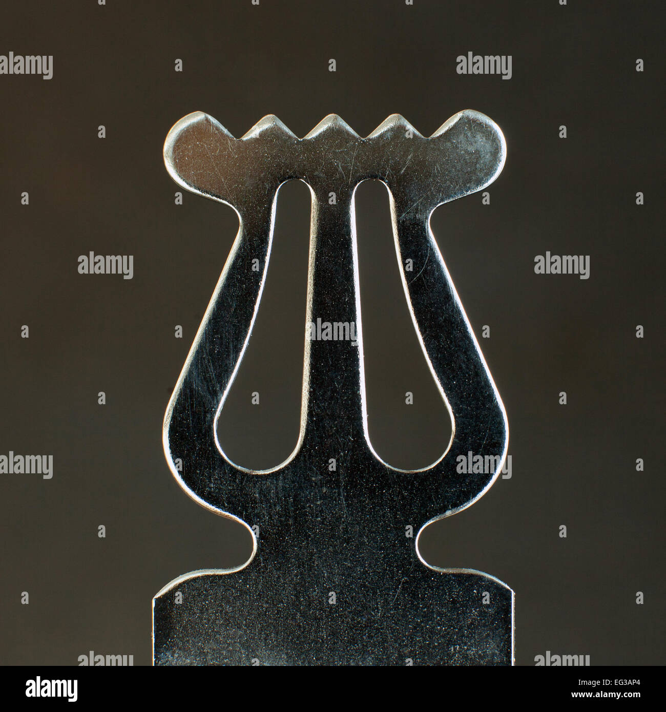 closeup of ornament on old metal music stand against dark background Stock Photo