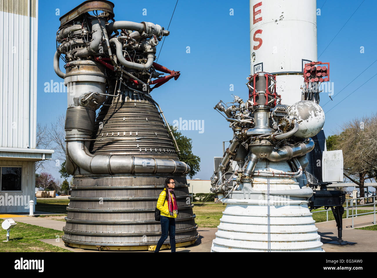 A female tourist walks in front of giant rocket engines at the Rocket Park, NASA Johnson Space Center, Houston, Texas, USA. Stock Photo