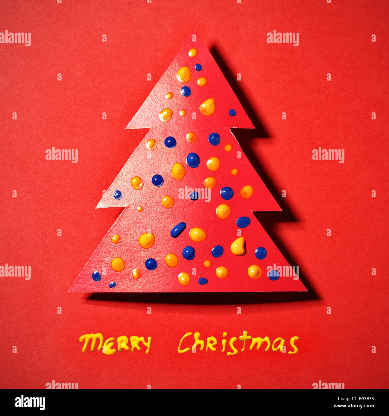 Paper Christmas tree on red background and wishes Stock Photo