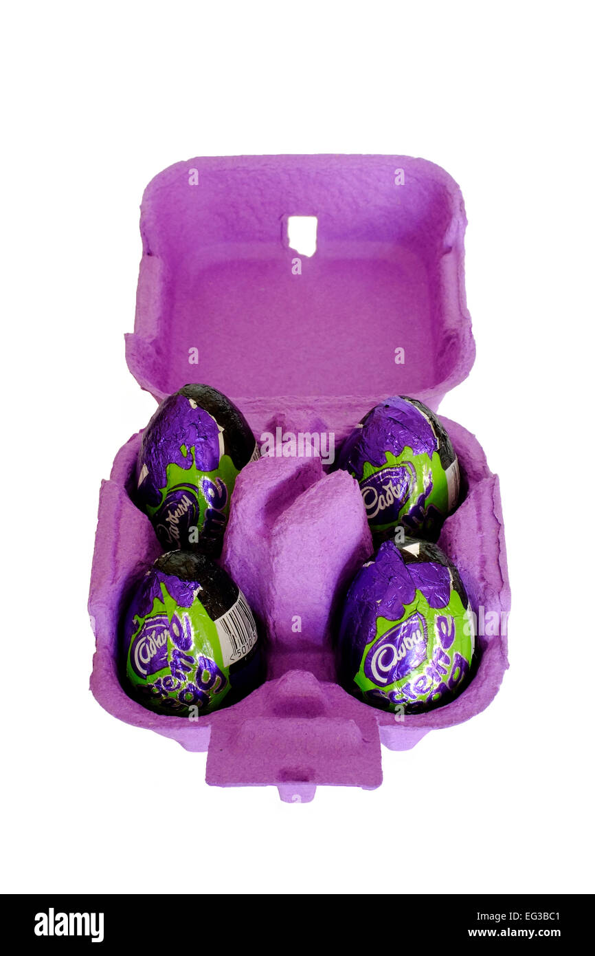 cadbury chocolate creme eggs with green foil wrappers in a purple egg