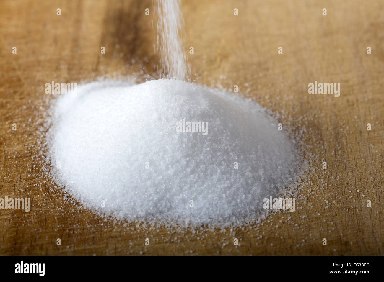 Salt pouring on a wood background Stock Photo