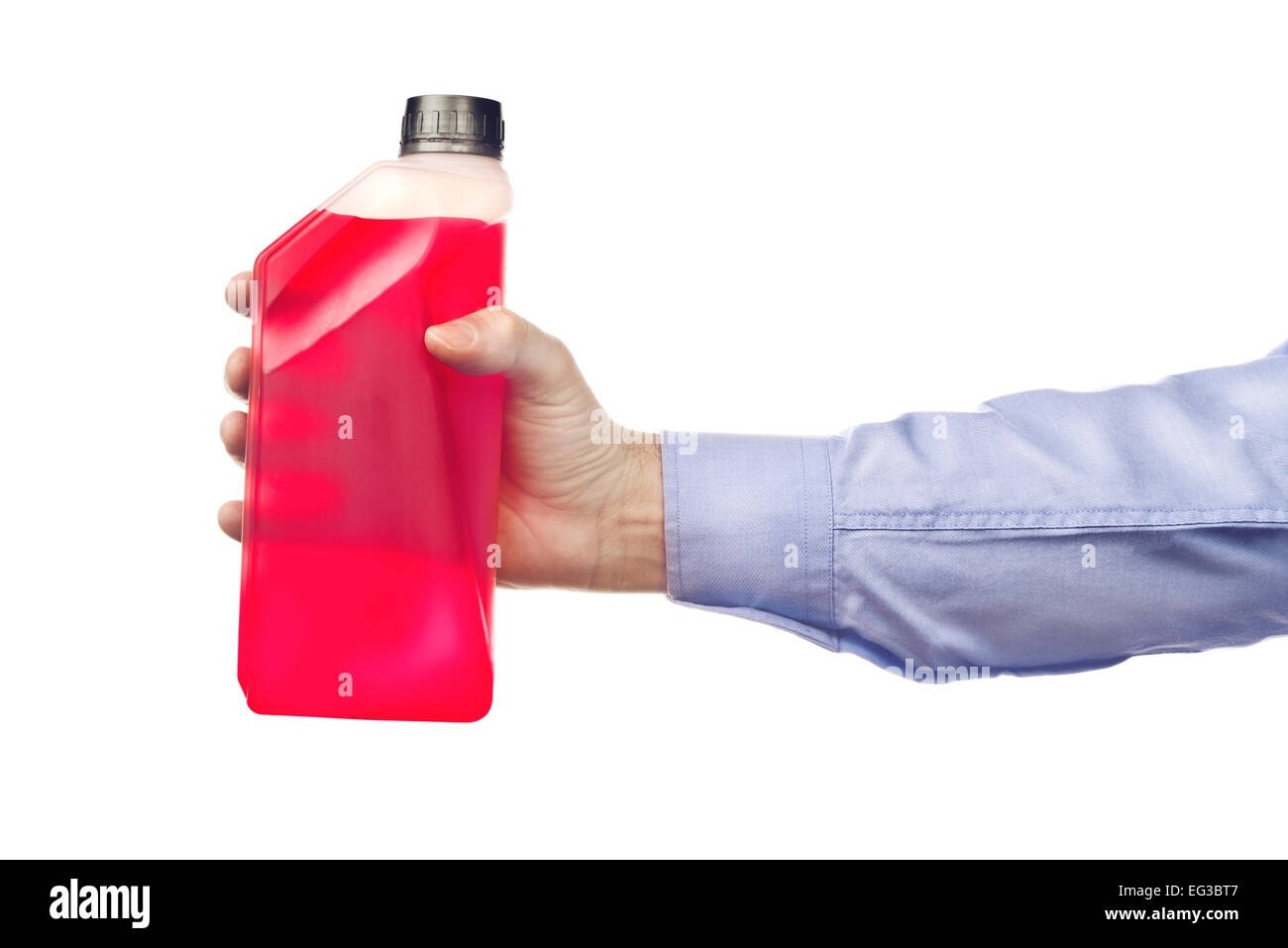 Male hand holding a bottle of antifreeze additive water-based liquid, isolated on white background. Stock Photo
