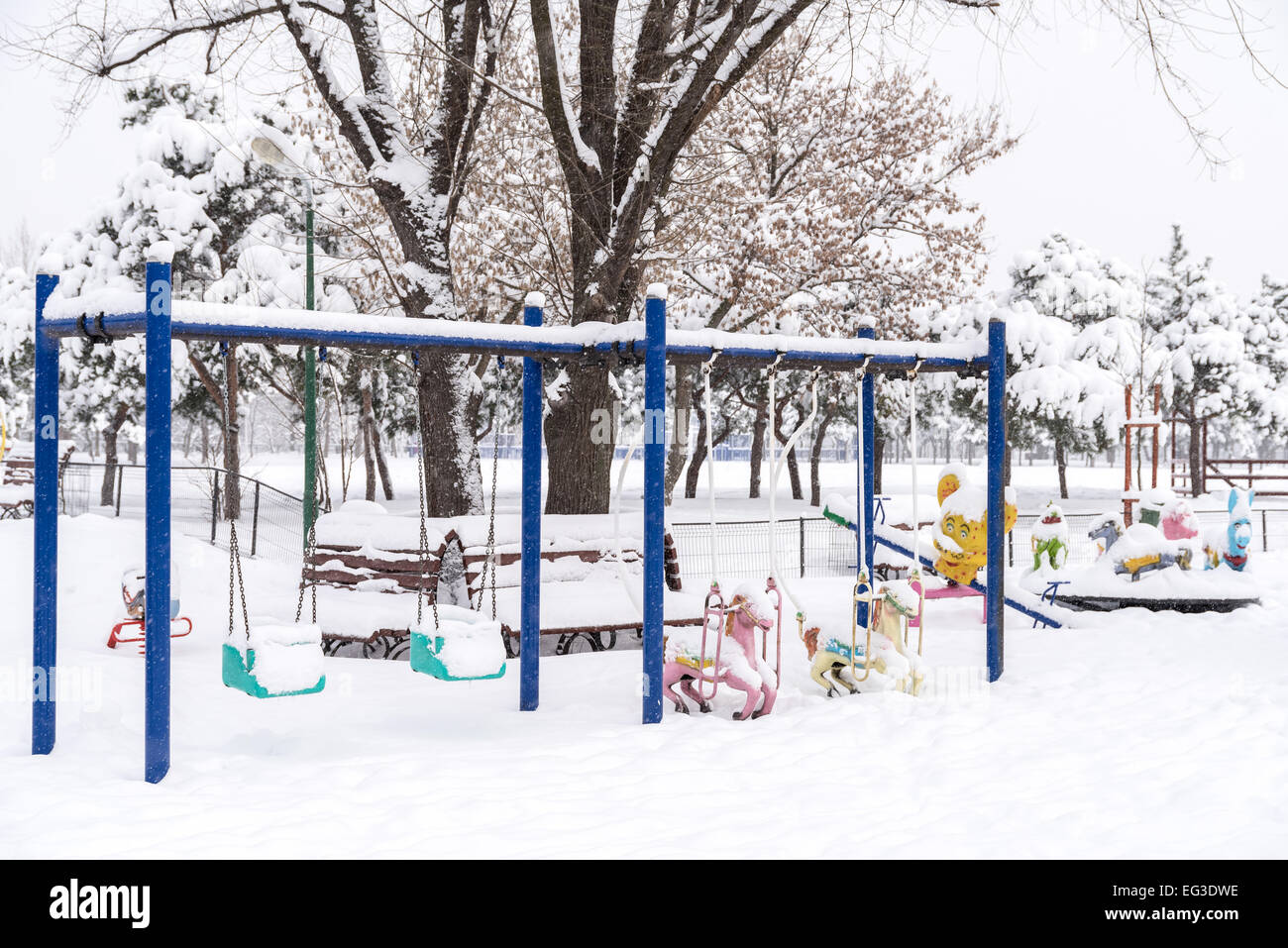 Children Playground In Public Park Covered With Winter Snow Stock Photo