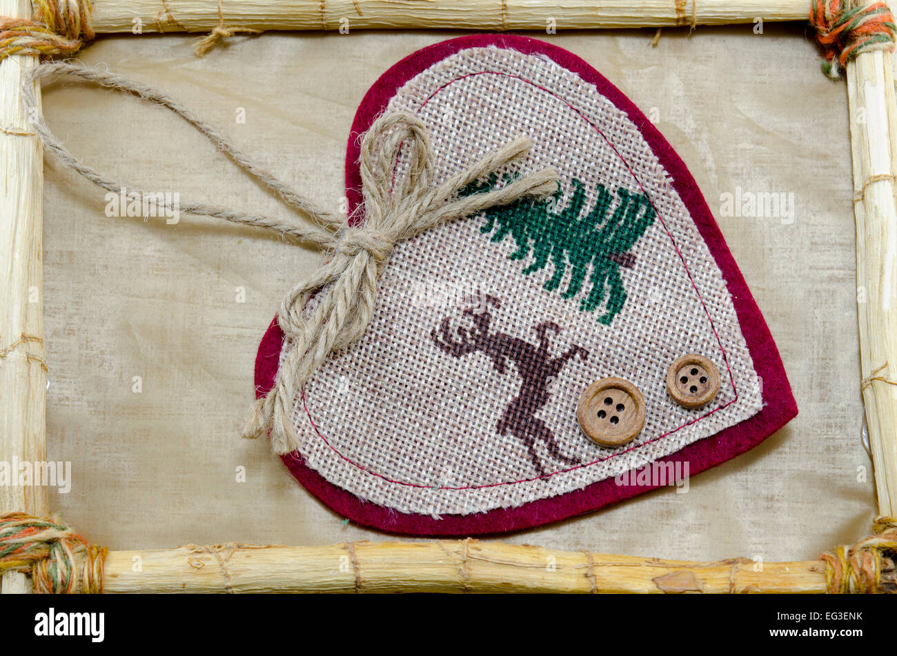 Handmade Christmas heart embroidery in a vintage bamboo frame Stock Photo