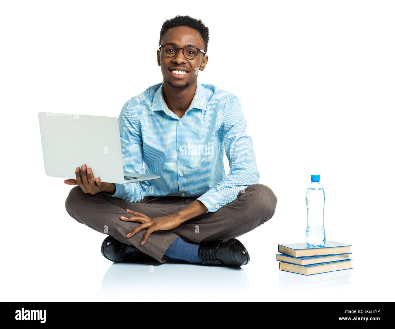 Happy african american college student sitting with laptop on white background Stock Photo