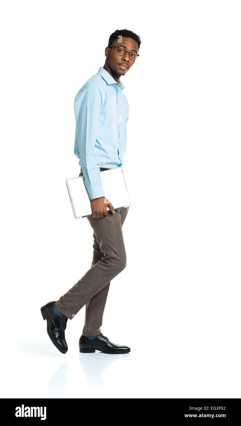 Happy african american college student standing with laptop on white background Stock Photo