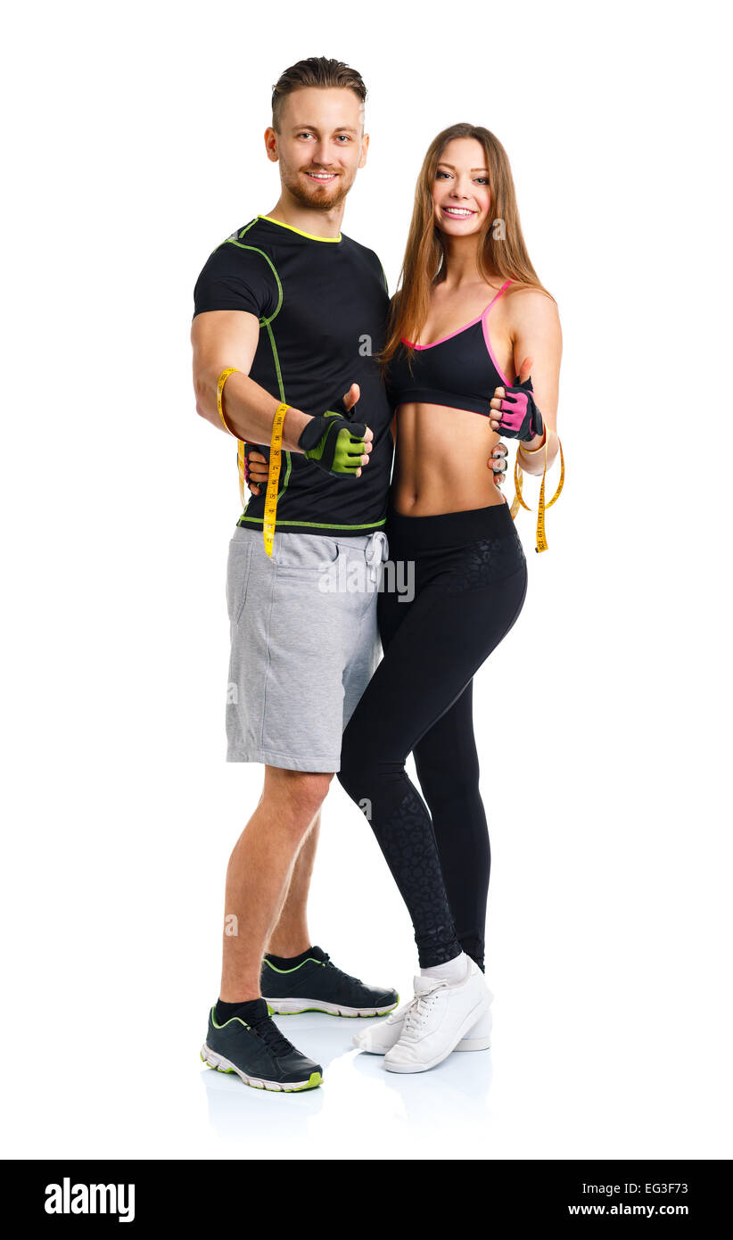 Happy sport couple - man and woman with measuring tape on the white background Stock Photo