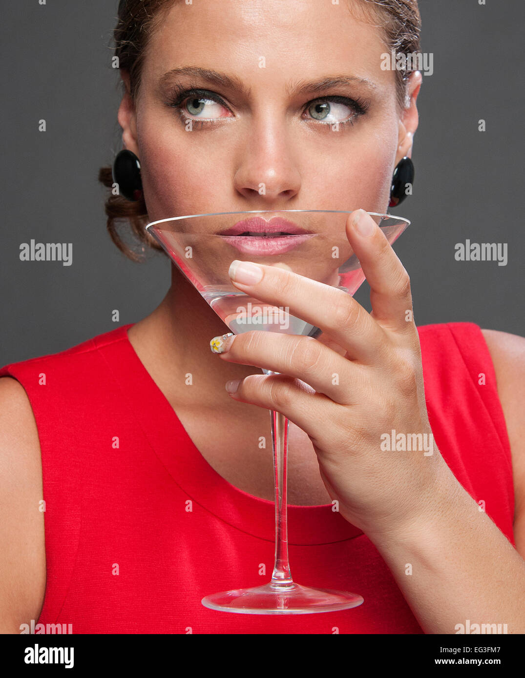 Woman drinking martini contemplating hi-res stock photography and ...