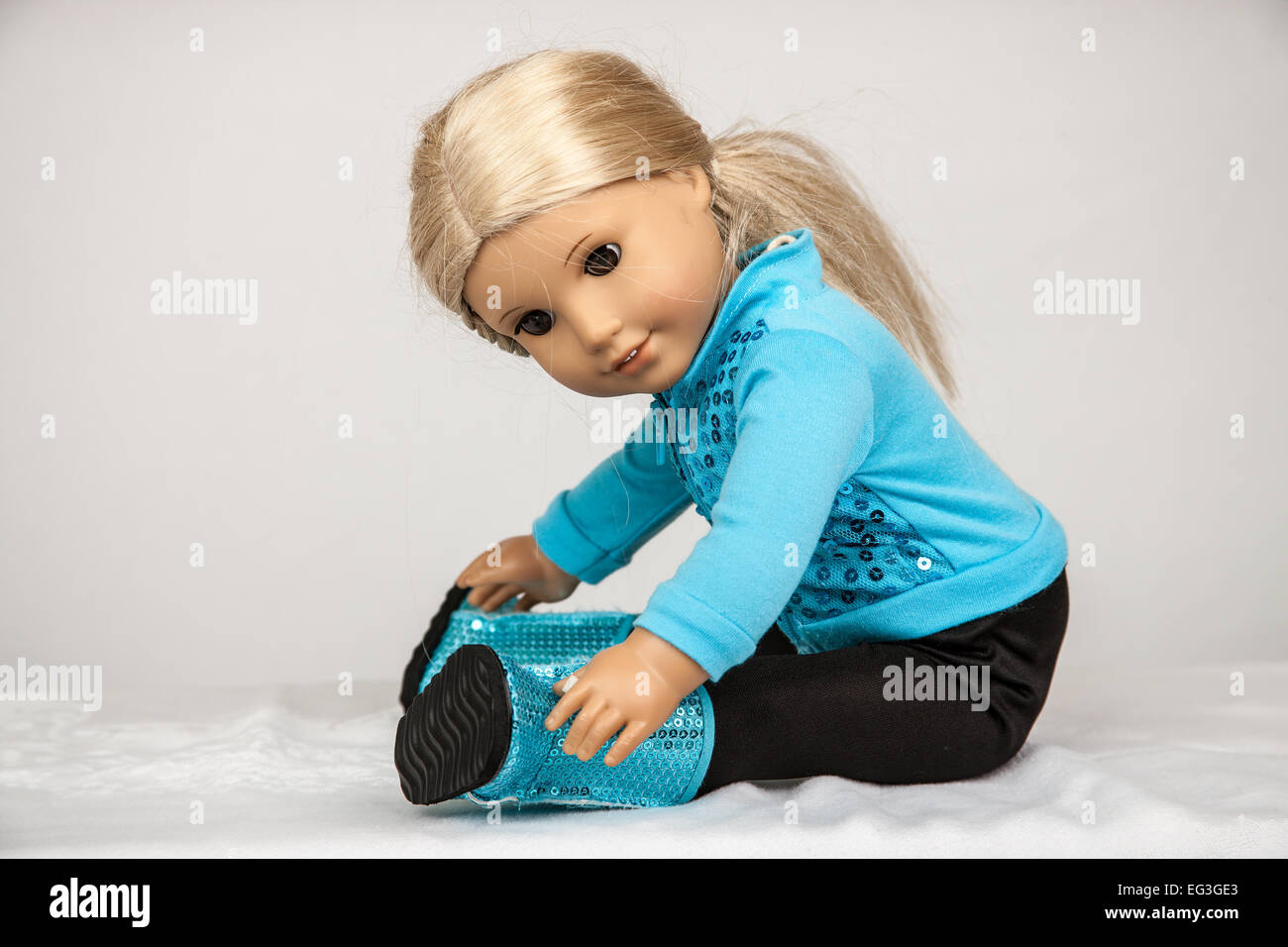 American Girl doll in her workout clothes doing sit-ups Stock Photo