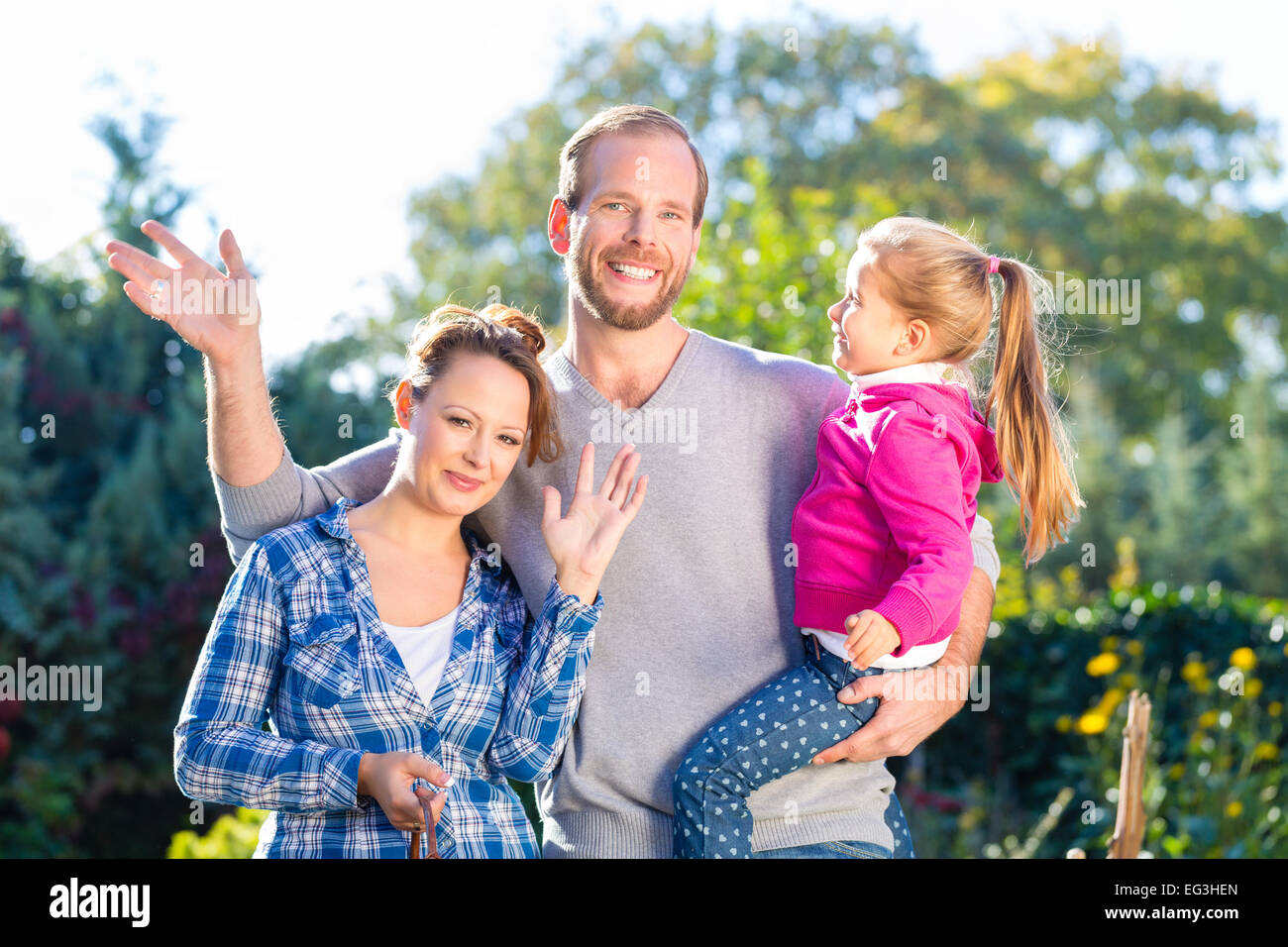 Mother, father and daughter in garden Stock Photo