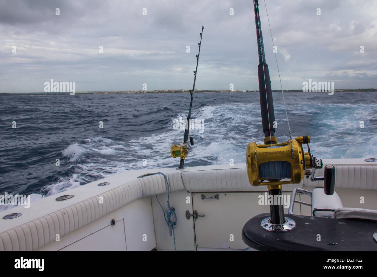 Two fishing rods with levelwind reels sit ready for action on a Caribbean fishing trip. Stock Photo