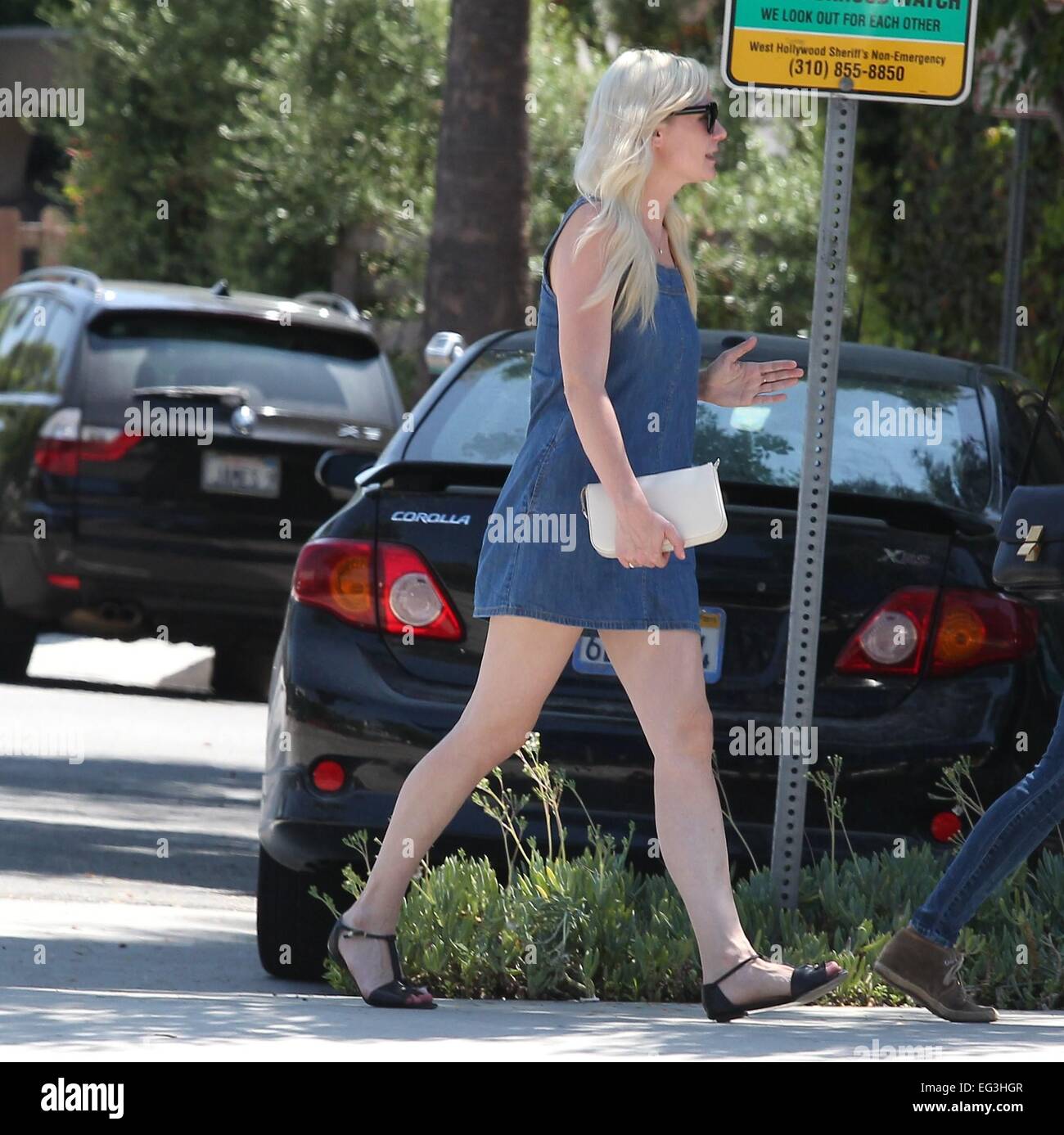 Kirsten Dunst wearing a denim summer dress and holding a white clutch out and about running errands  Featuring: Kirsten Dunst Where: Los Angeles, United States When: 13 Aug 2014 Stock Photo