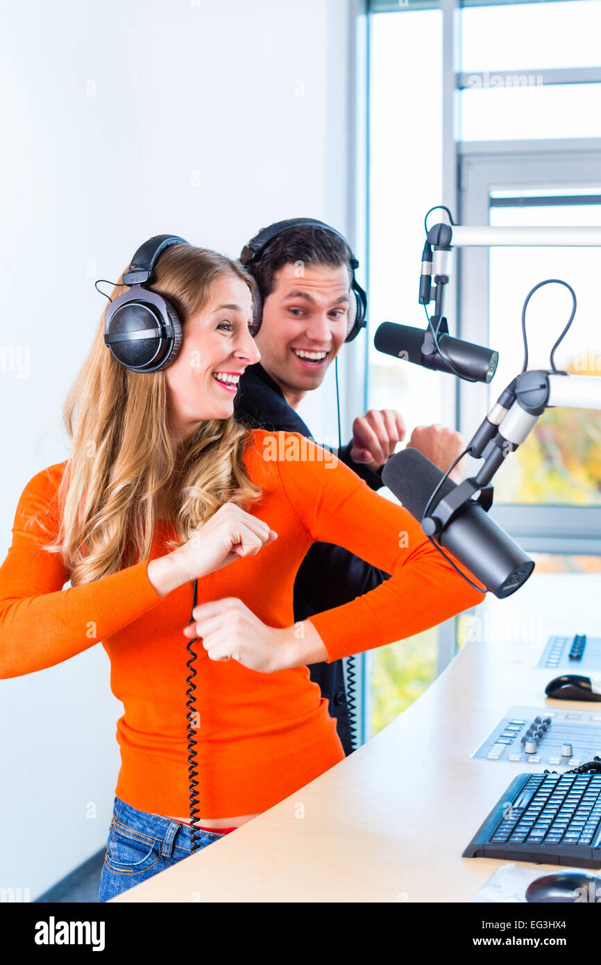 Presenters or moderators - man and woman - in radio station hosting show  for radio live in Studio Stock Photo - Alamy