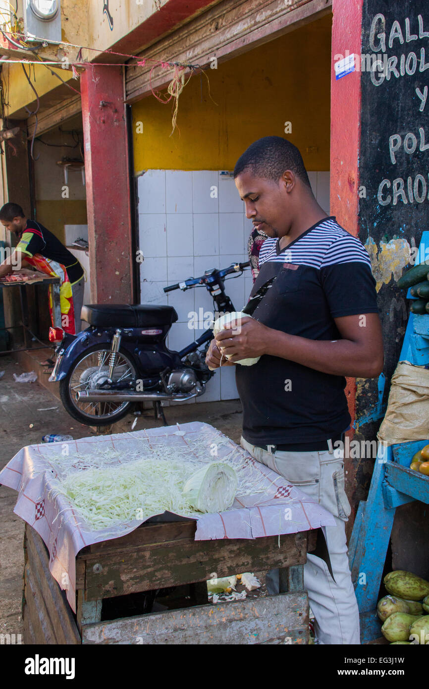 A street vendor in Higuey, Dominican Republic chops cabbage on the