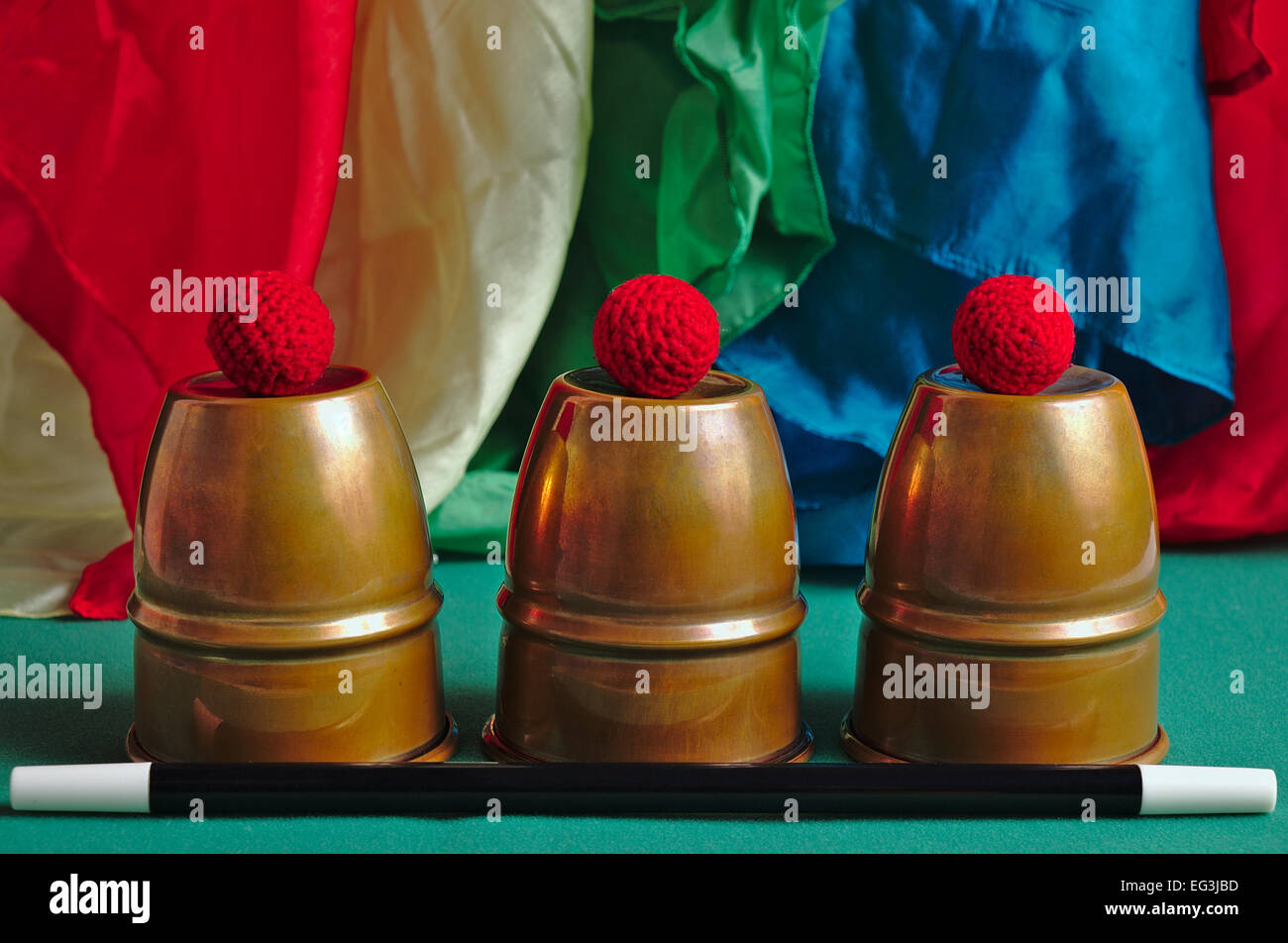 Magic props on display on a table: cups and balls, magic wand and hankies. Magicians and Illusionists Stock Photo