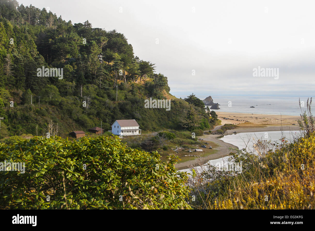 Looking down from the Highway One towards a home on a inlet and the Pacific Ocean beyond, Mendocino County, California Stock Photo