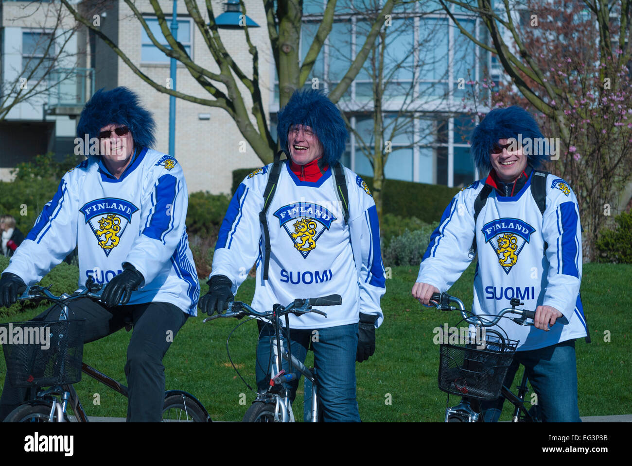 Vancouver, Canada-Feb,17,2010: Three of Team Finland fans riding bicycles during 2010 Winter Olympic Games. Stock Photo
