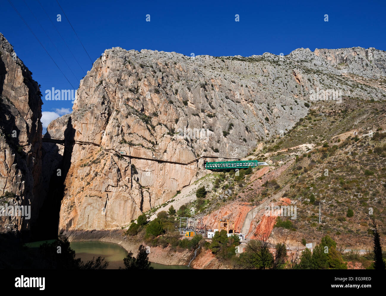 Train exiting tunnel near El Caminito del Rey running along the right cliff, El Chorro, Malaga Province, Andalucia, Spain Stock Photo