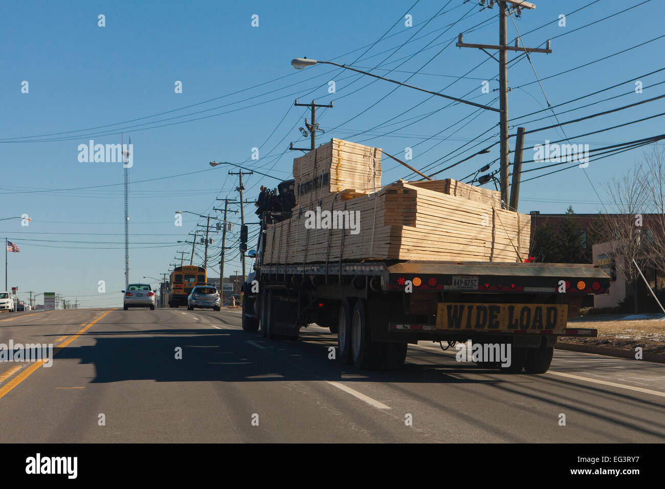 Flatbed tractor trailer loaded with lumber on road - USA Stock Photo