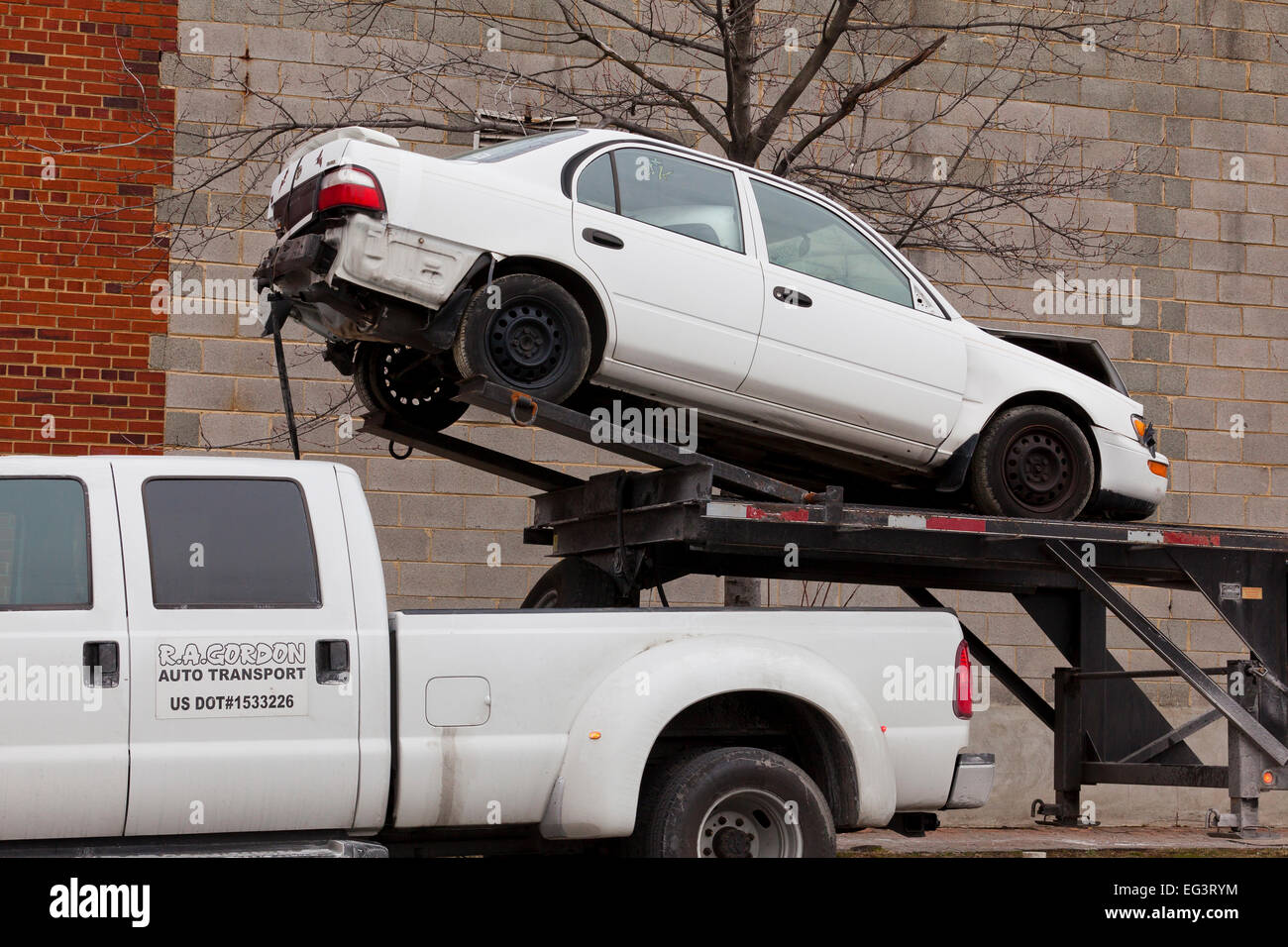 Damaged car loaded on auto transport trailer Virginia USA Stock Photo