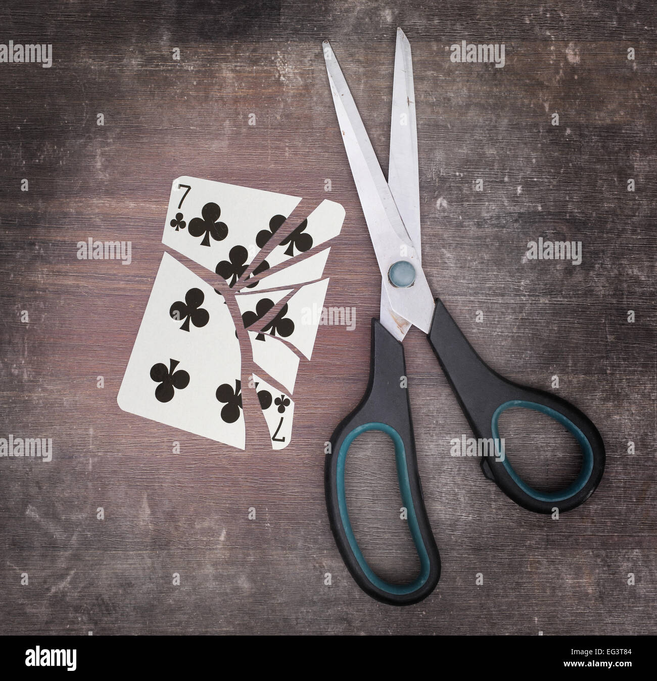 Concept of addiction, card with scissors, seven of clubs Stock Photo