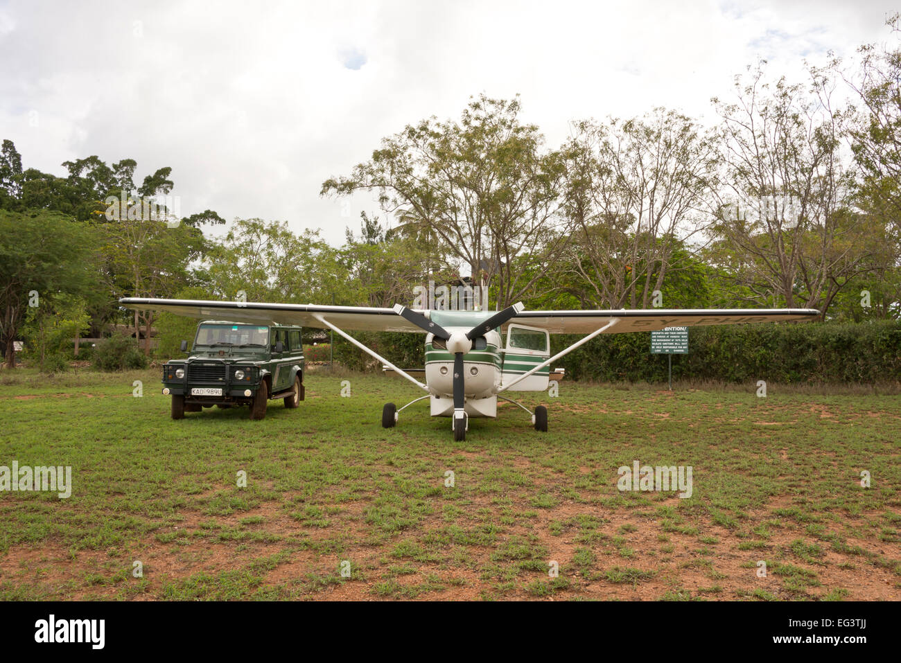 Landrover and light aircraft cessna 206 parked alongside at Taita Hills in Kenya, East Africa ready for safari Stock Photo