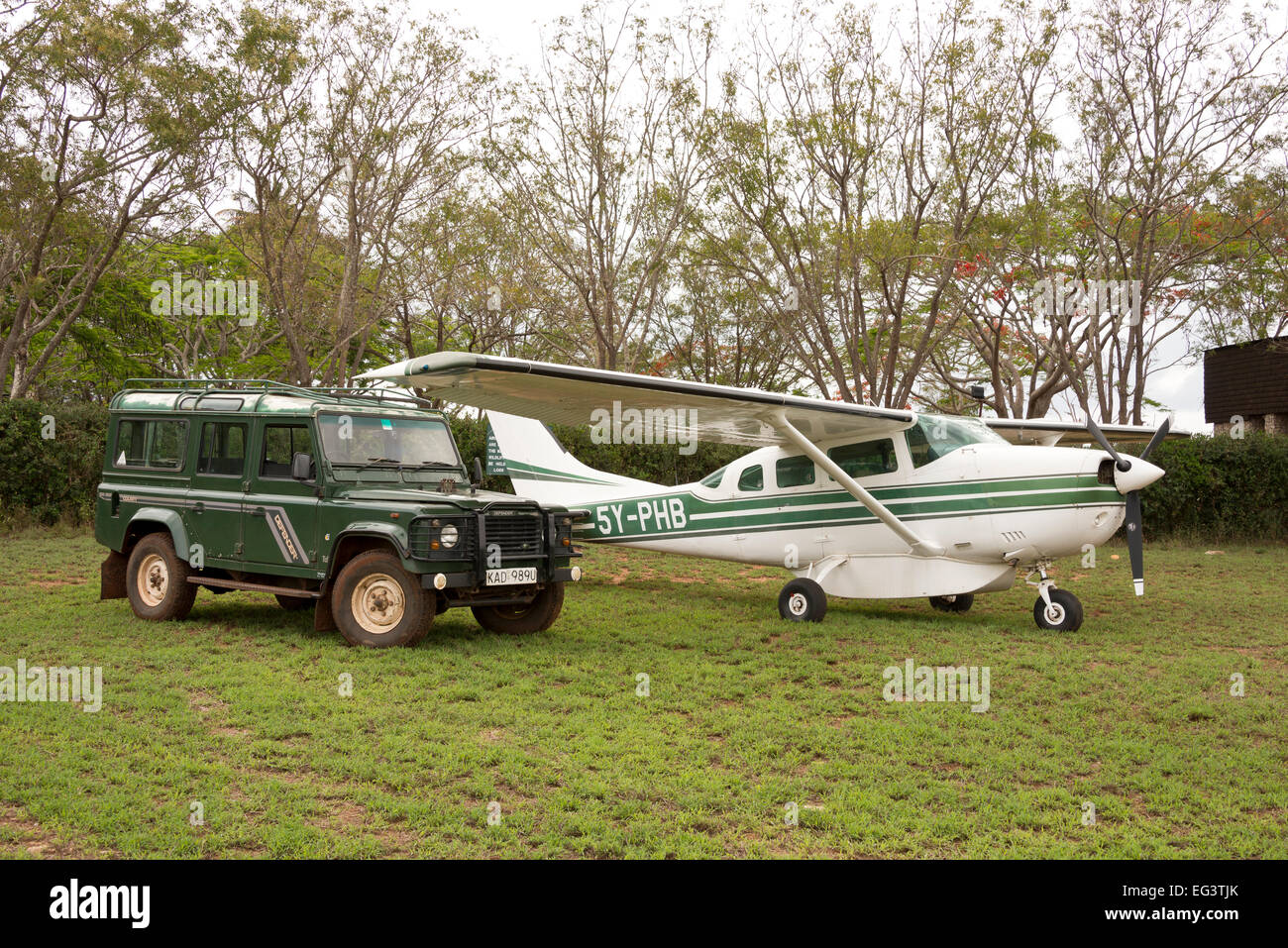 Landrover and light aircraft cessna 206 parked alongside at Taita Hills in Kenya, East Africa Stock Photo