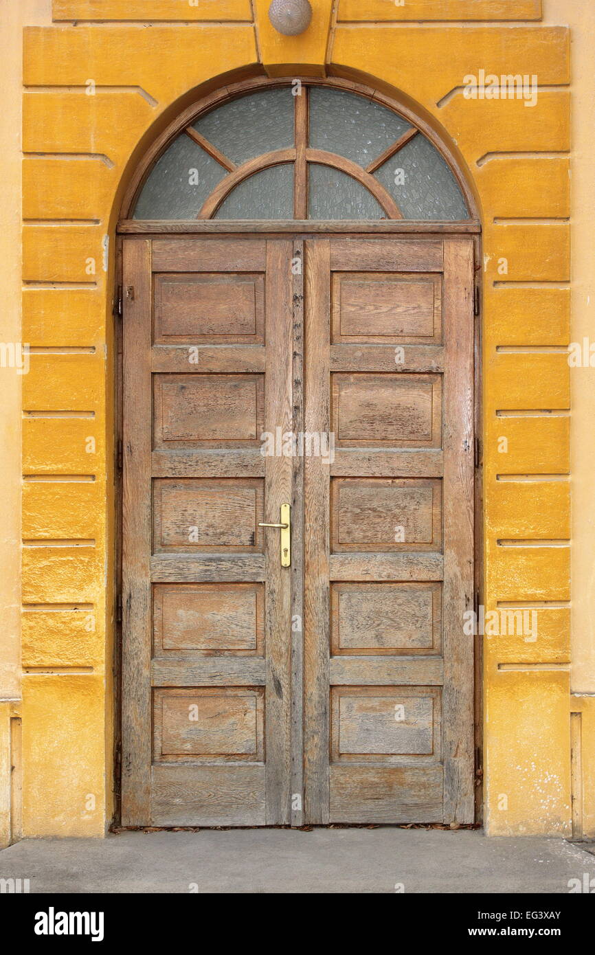old wooden traditional door on building facade Stock Photo