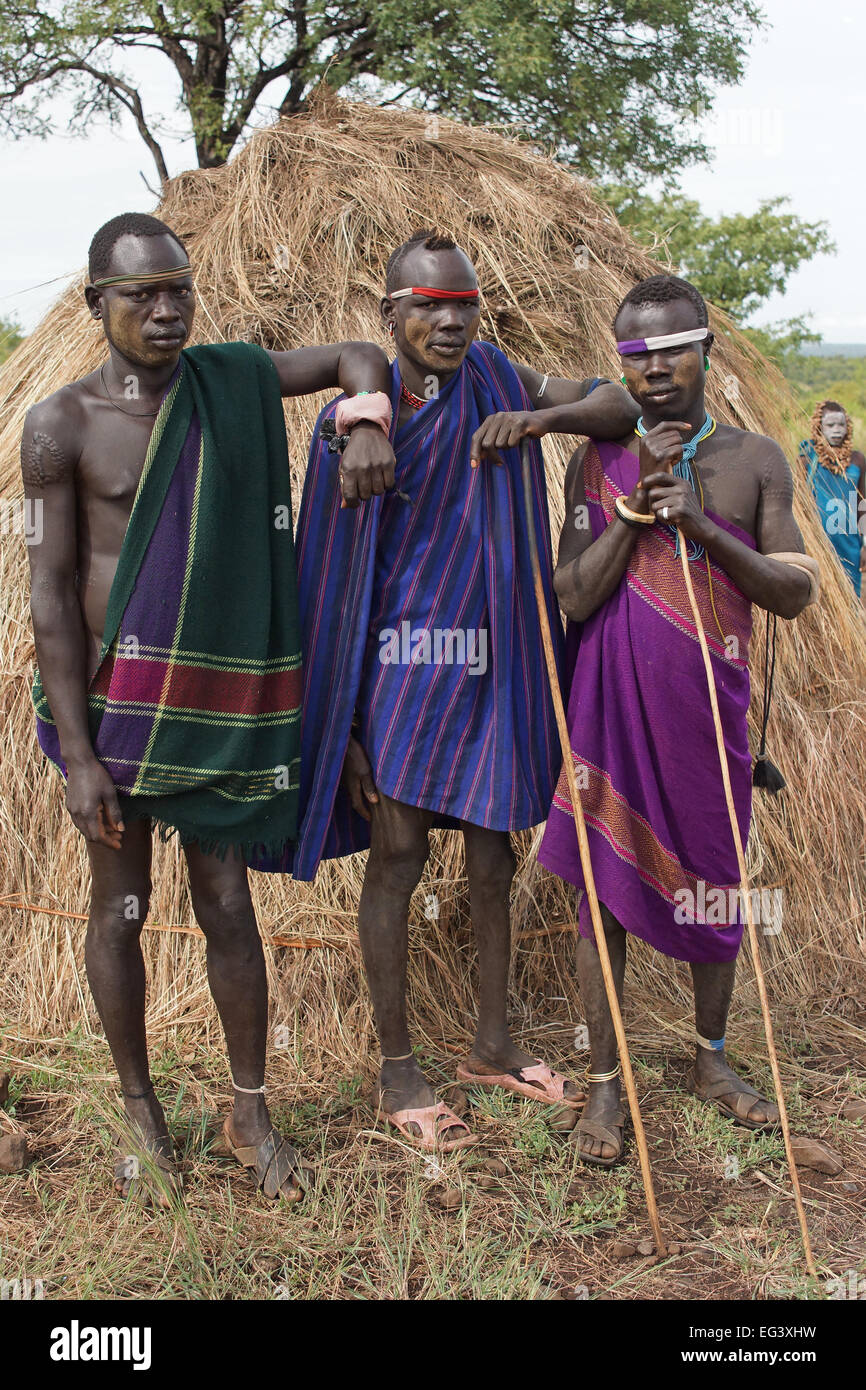 JINKA, ETHIOPIA - NOVEMBER 21, 2014: Mursi men with traditional clothings on November 21, 2014 in Jinka, Ethiopia. Stock Photo