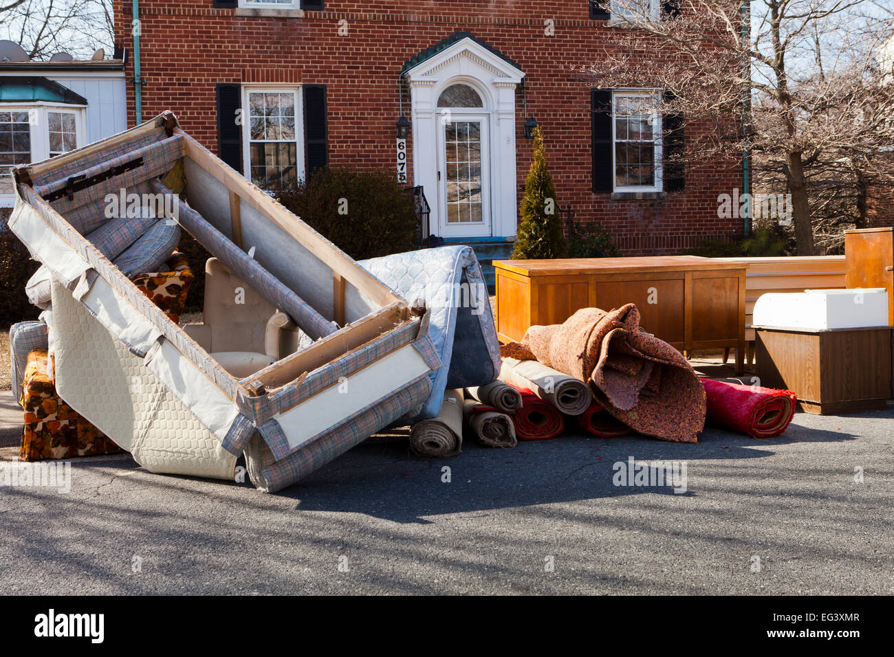 Furniture piled outside of house after eviction of tenant - Virginia USA Stock Photo