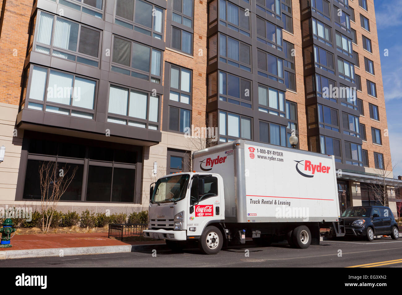 Ryder rental box truck in front of highrise apartment building USA