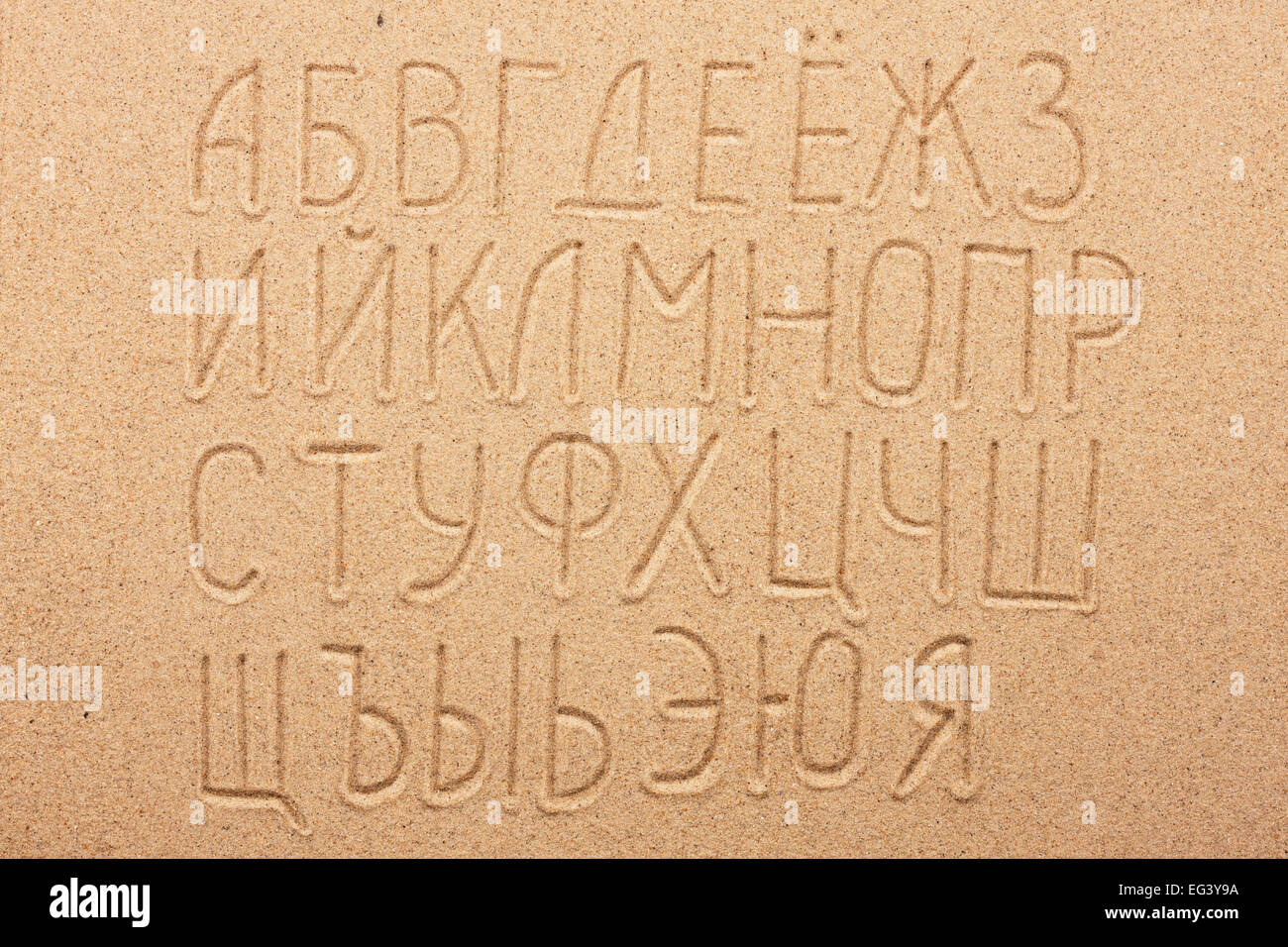 Russian alphabet  written on the sand, as background Stock Photo